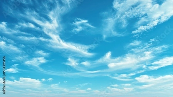 Fototapeta A tranquil empty sky with high, thin cirrus clouds stretched like brushstrokes across a pale blue background.