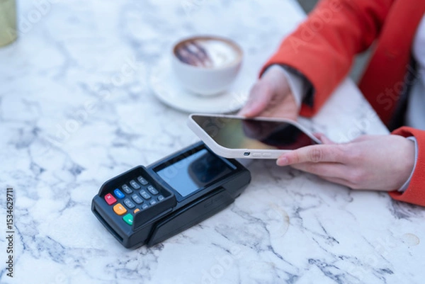 Obraz Mobile payment transaction at a cafe table during a relaxed afternoon with coffee and pastries