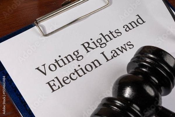 Fototapeta A legal document titled "Voting Rights and Election Laws" is placed neatly on a wooden desk, accompanied by a judge’s gavel, symbolizing authority and legal enforcement.