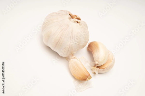 Fototapeta Photographic still life of garlic bulb and cloves for culinary blogs recipe websites or nutritional content food photography style