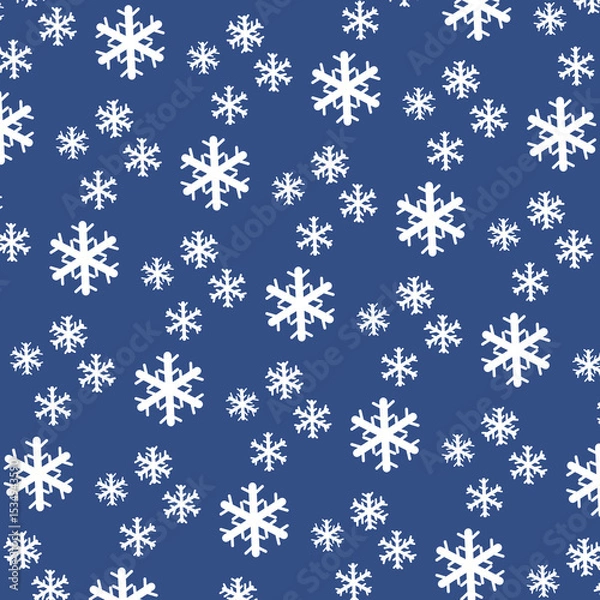 Fototapeta Delicate white snowflakes of various sizes fall against a soft light blue background, evoking a peaceful winter ambiance and a sense of tranquility.