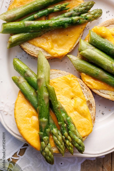 Obraz Asparagus open sandwiches with melted cheese, top view