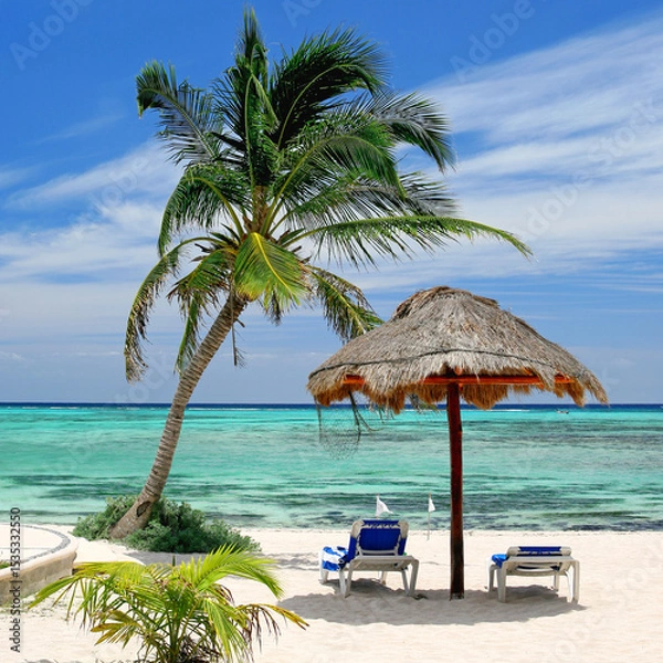 Fototapeta Seaside Tranquility: A Palm Tree, Sun Umbrella, and Two Lounge Chairs Overlooking Turquoise Caribbean Waters and Pristine White Sands
