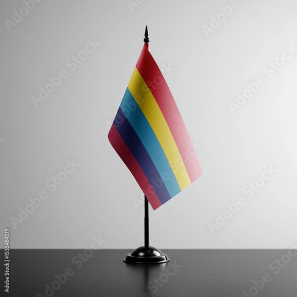 Fototapeta Rainbow flag displayed on a black stand against a minimalist backdrop  
