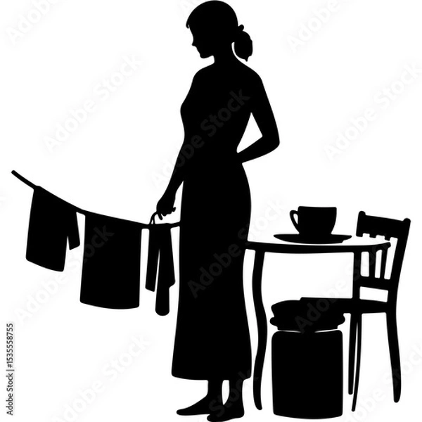 Fototapeta Woman hanging laundry while standing next to a table with a cup  