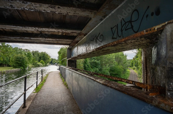 Fototapeta Southall, Greater London, UK: Windmill Bridge, more commonly known as Three Bridges is an engineering structure where a road crosses the Grand Union Canal which crosses a railway all at the same point