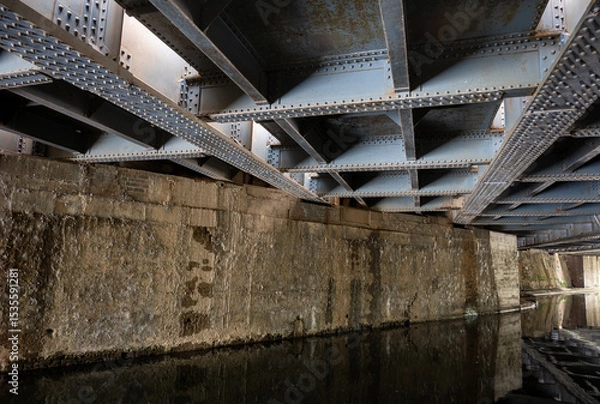 Fototapeta Underside of the railway bridge where the Great Western Main Line crosses the Grand Union Canal in Hayes, West London, UK.