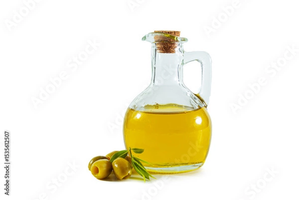 Fototapeta Extra virgin olive oil in a transparent jug and green olives with leaves.