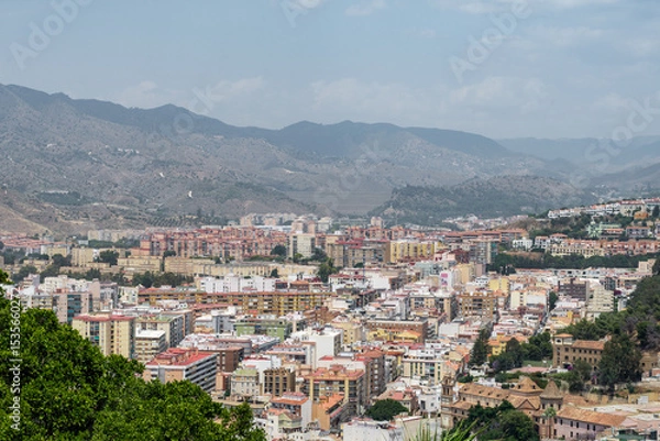 Fototapeta Title: Modern Málaga cityscape with iconic twin towers and residential neighborhoods seen from the elevated Gibralfaro viewpoint.