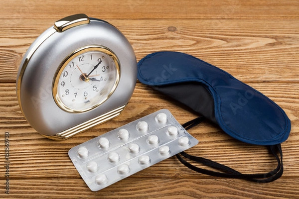 Obraz Alarm clock, mask and sleeping pills on a wooden background 