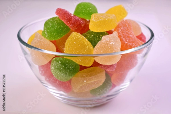 Obraz Jelly candies, marmalade in a transparent bowl on a white background. Close-up.
