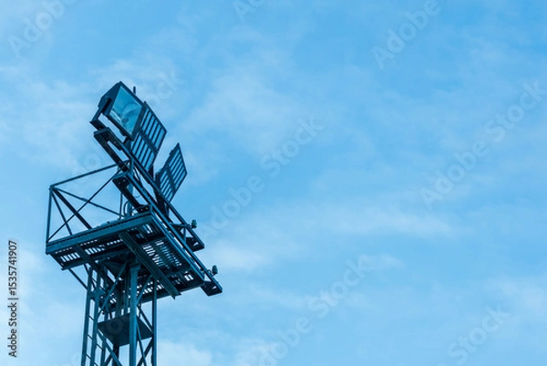 Obraz a lighting mast with floodlights powered by electricity