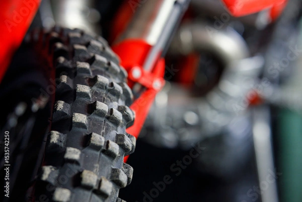 Obraz A close up of a red dirt bike tire with black tread