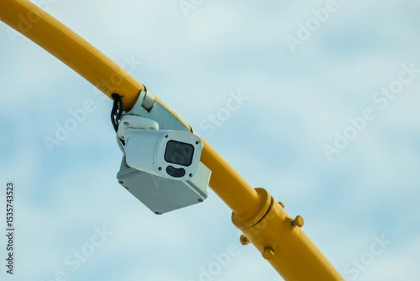 Obraz A camera is mounted on a yellow pole
