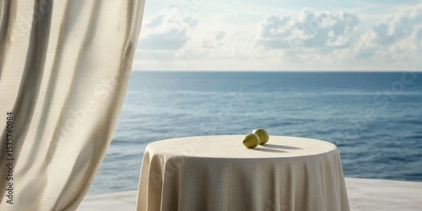 Fototapeta A serene seaside scene featuring a table with a soft cloth and decorative objects, perfect for evoking tranquility and relaxation in hospitality or lifestyle themes.