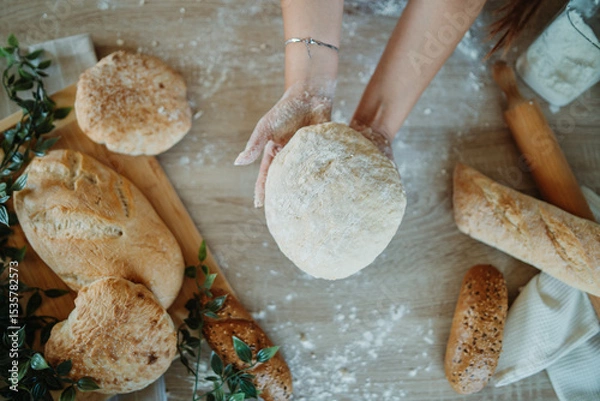 Obraz Top view of young caucasian woman's hands kneading a dough 
