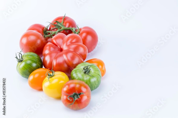 Obraz Different colors and shapes tomatoes isolated on white background. Liked by branch.