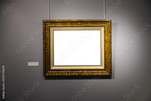 Fototapeta In an art museum, a picture frame with an empty canvas hangs on the wall