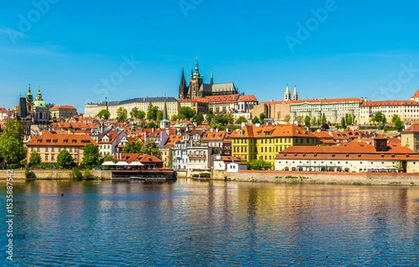 Fototapeta A view across the Vltava river beside the Charles bridge in Prague in springtime