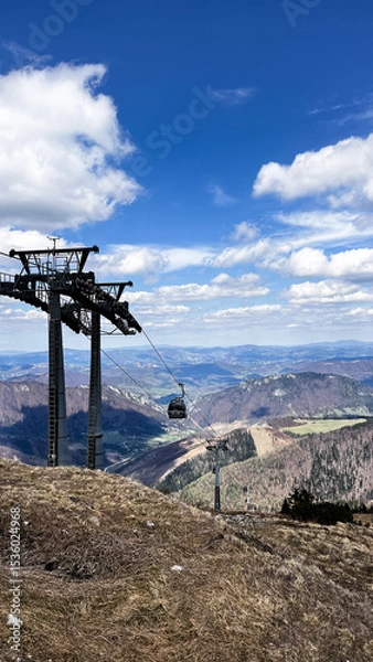 Fototapeta Vertical photo of mountain view with towers of cable car bringing tourist for hiking and skying and snowboarding in winter on Chleb over Vratna dolina in Mala Fatra in Slovakia.