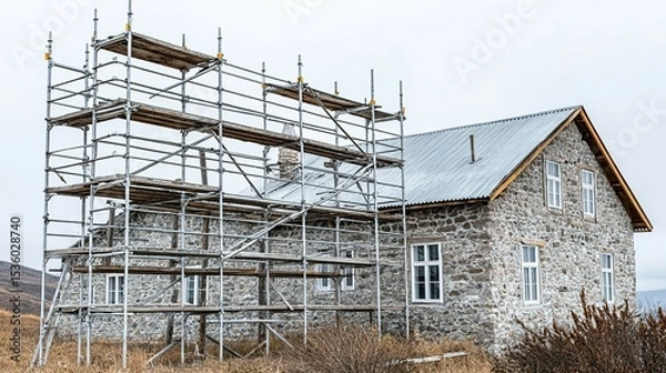 Fototapeta Stone building under construction with scaffolding.