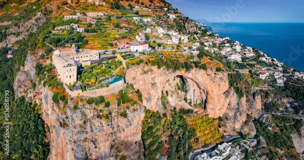 Obraz Aerial summer view from flying drone of Santa Maria di Grado drone, located on the huge cliff on Mediterranean coast of Italy, Europe. Traveling concept background.