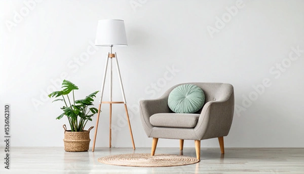Fototapeta Minimalist Interior with Accent Chair: A simple interior design showcases an elegant chair with a decorative cushion, complemented by a modern floor lamp and a potted plant for a touch of greenery.