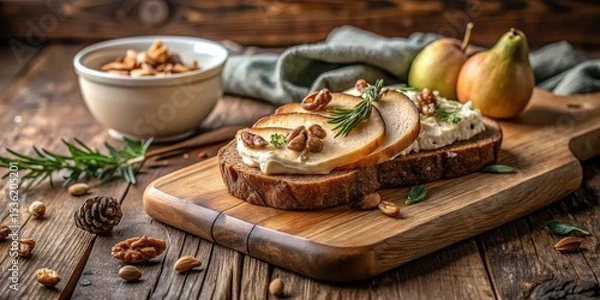 Fototapeta A delectable open-faced sandwich featuring creamy cheese, sweet pear slices, and crunchy walnuts, artfully arranged on rustic wooden board