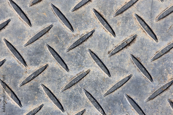 Fototapeta Weathered metal surface with a diamond plate pattern close-up abstract textured background