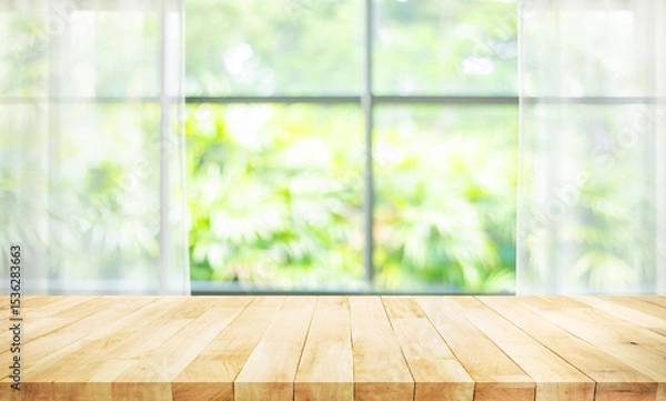 Fototapeta Selective focus.Wood table counter top on blur curtain window with green troptcal garden background.