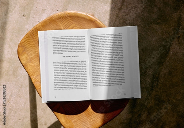Fototapeta Mockup Of Customized Hardback Book Open On Stool