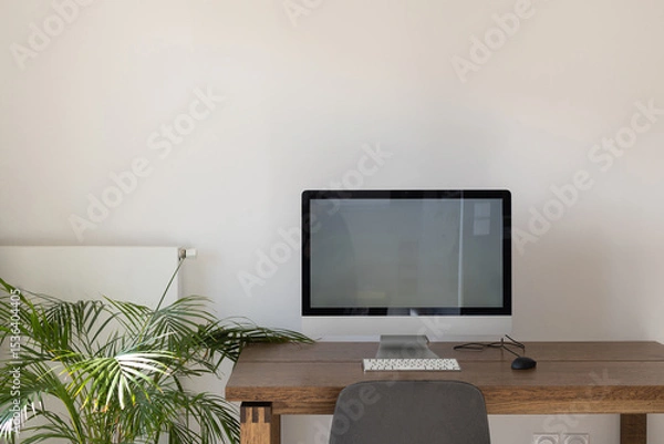 Fototapeta desktop computer with big empty screen, modern workplace interior with copyspace, white wall
