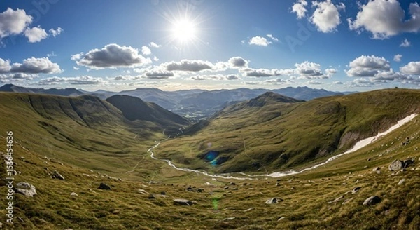 Fototapeta a view of a valley with mountains and a river