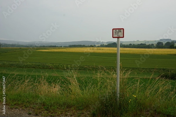 Obraz Water hydrant sign post in countryside, farmlands in background