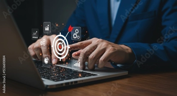 Fototapeta A businessman uses a laptop with digital target and business icons showing strategy and goals