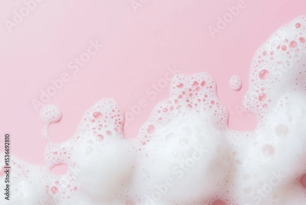 Fototapeta Beauty Product Foam Soap. Abstract background white soapy foam flowing texture. Shampoo foam with bubbles. Bubble surface isolated on pastel pink coral rose color. Suds. Facial cleanser. Froth Pattern