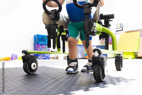 Fototapeta Walker for rehabilitation and restoration of walking of child in rehabilitation center, close-up . Mobility aids in pediatric physiotherapy
