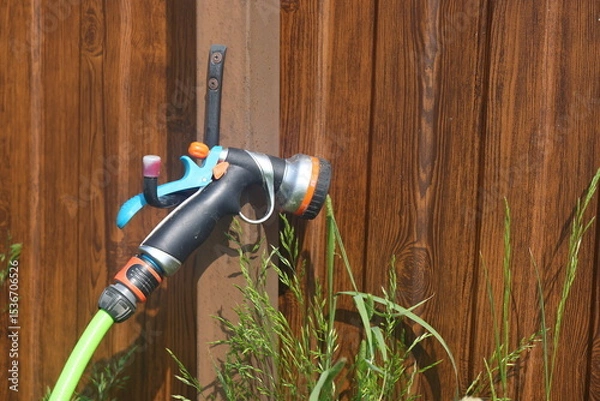 Fototapeta Tap and hose for watering a summer cottage, irrigation system, gardening, 2