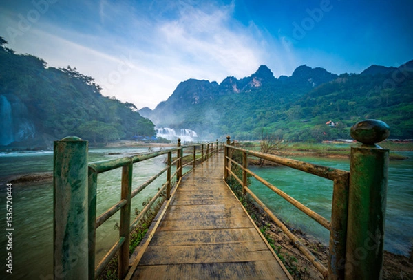 Fototapeta Bridge to Ban Gioc Waterfalls, a famous cross-border waterfall between Vietnam and China