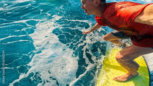 Obraz Person in red shirt surfs the wave in the tropics