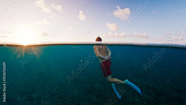 Obraz Man swims in the sea with breaking waves. Splitted shot of the male swimming in the ocean on a surfing spot