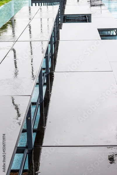 Fototapeta Abstract background. Stadium stand after rain. Reflections in puddles.