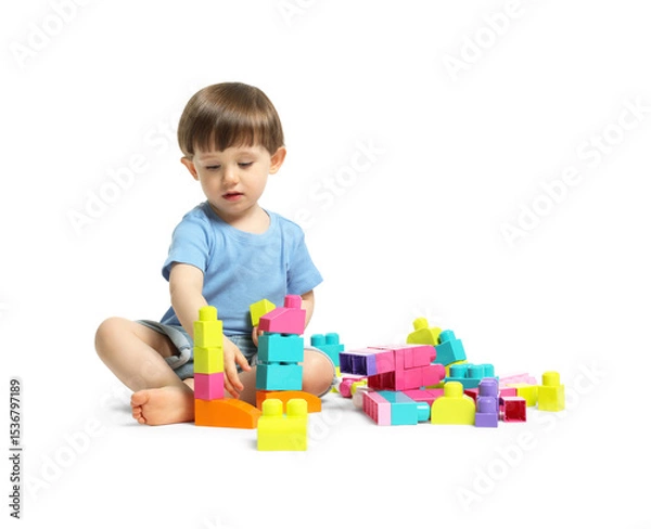 Fototapeta Cute little boy playing with building bricks on white background