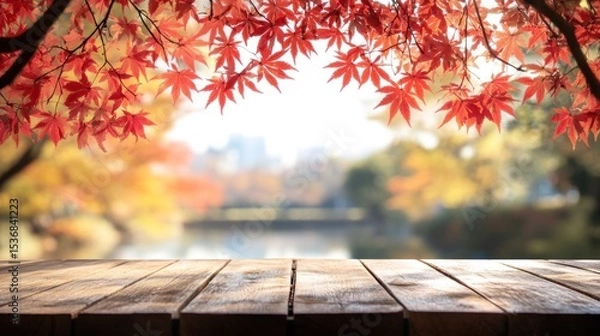 Obraz Autumnal scene with vibrant fall foliage over a wooden surface.