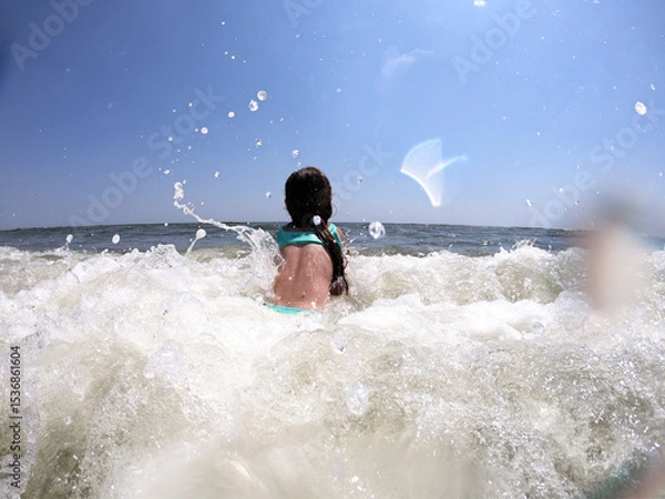 Obraz Powerful ocean waves splashing on child girl in summer vacation
