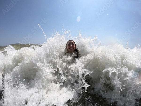 Obraz Powerful ocean waves splashing on child girl in summer vacation