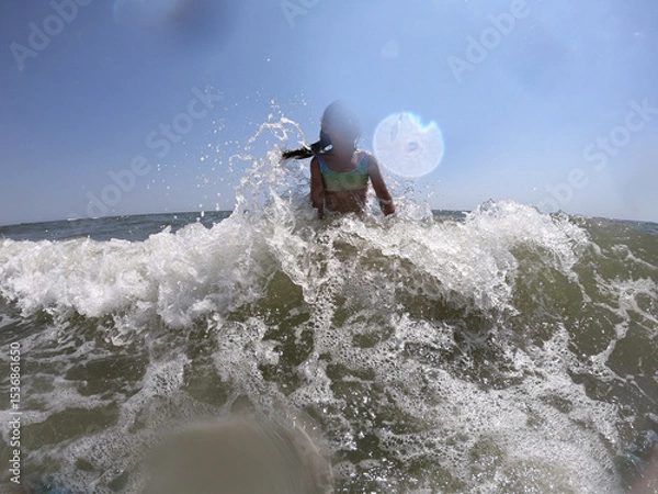 Obraz Powerful ocean waves splashing on child girl in summer vacation