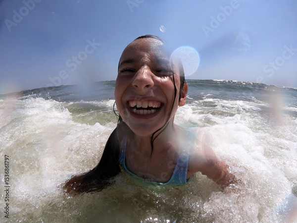 Obraz Powerful ocean waves splashing on child girl in summer vacation