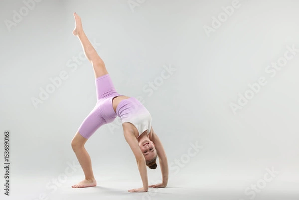 Obraz Girl in stylish clothes dancing on light grey background, space for text