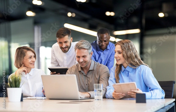 Fototapeta Five business professionals using laptop on desk discussing strategy company.